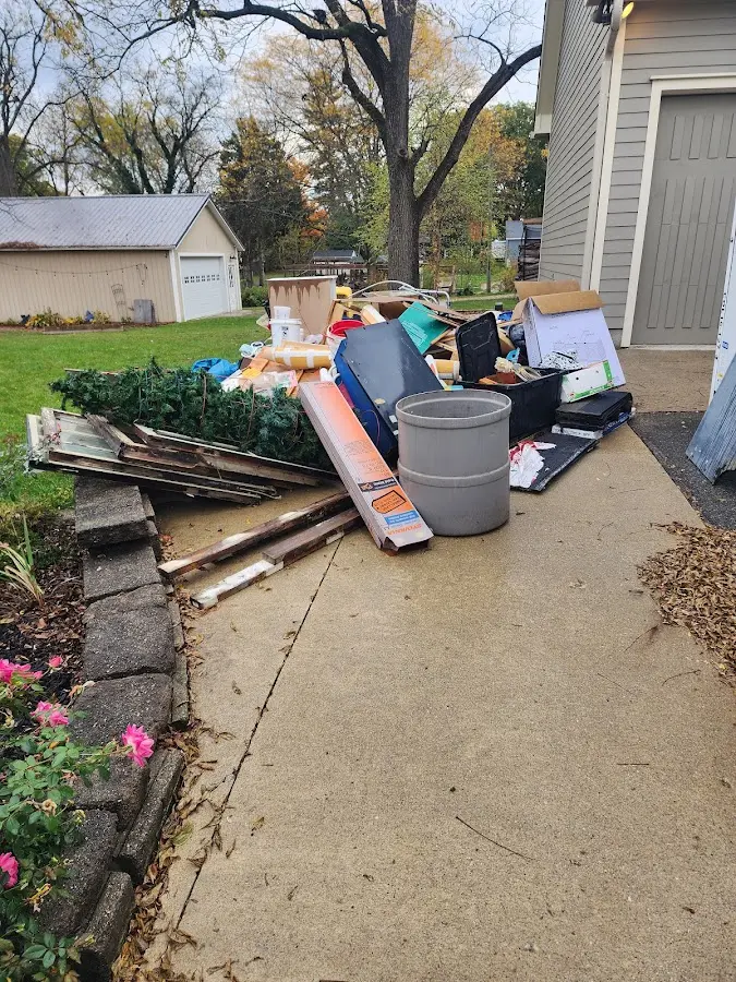 Dumpster being loaded with debris for 12 Yard Dumpster Rental in Morristown